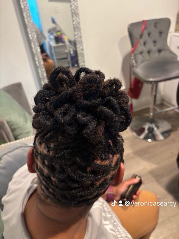 Interlocking locs in a high bun